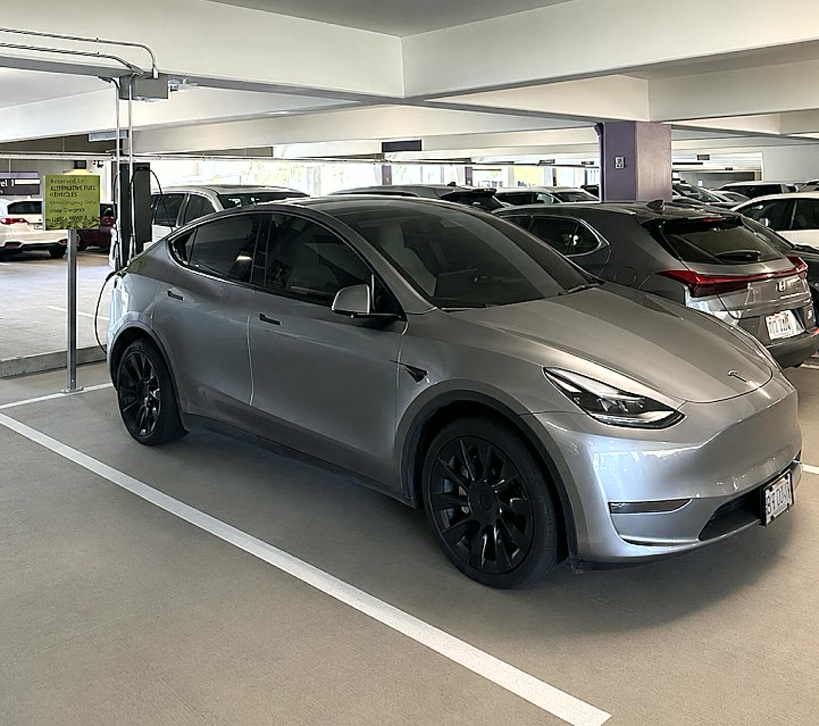 Tesla Model Y charging at a Level 2 station in the South Shore Market parking garage